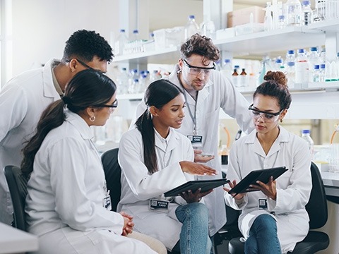 group of people in white lab coats