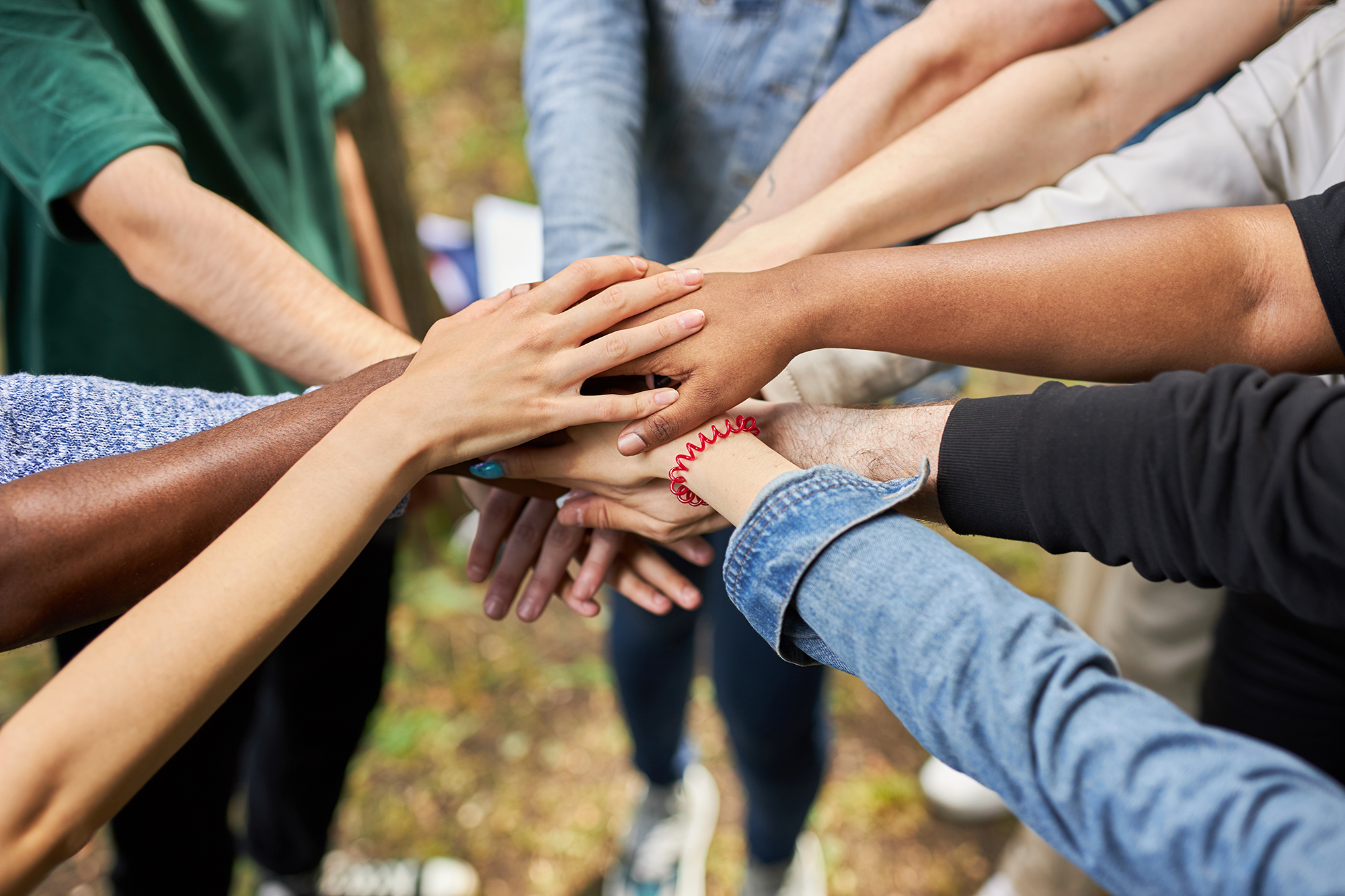 a group of people joining hands