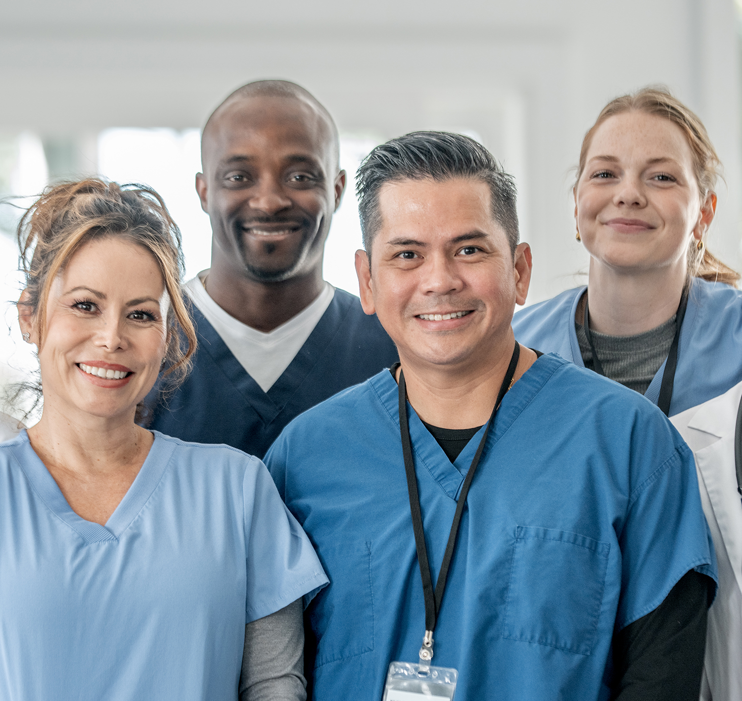 four healthcare providers smile