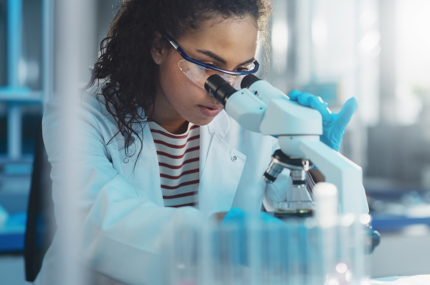 young scientist looking into a microscope