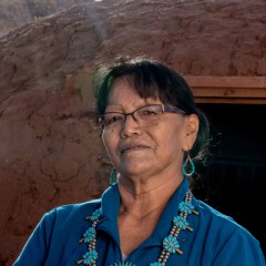woman standing in front of a red rock wall