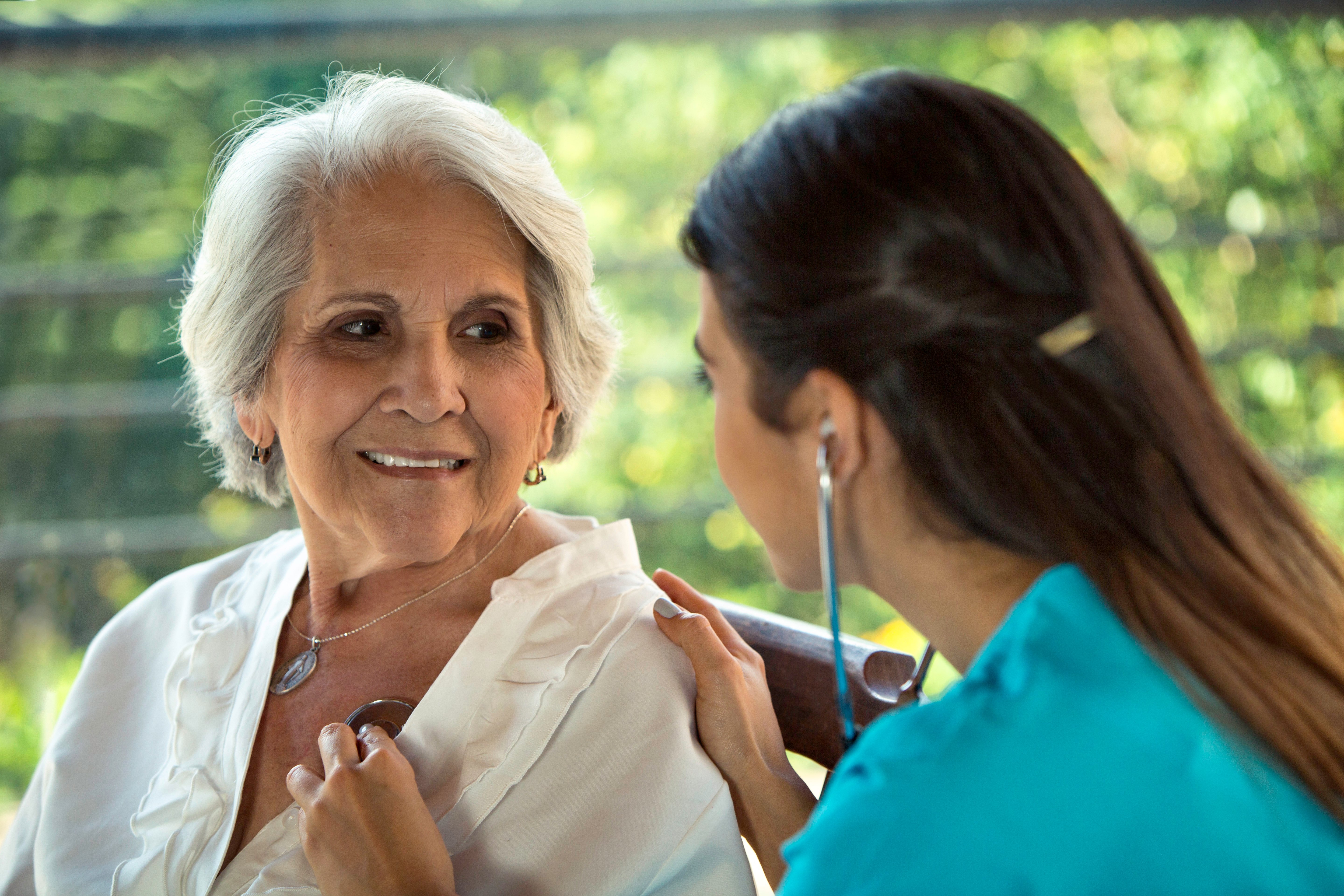 Physician listens to senior patient’s heart