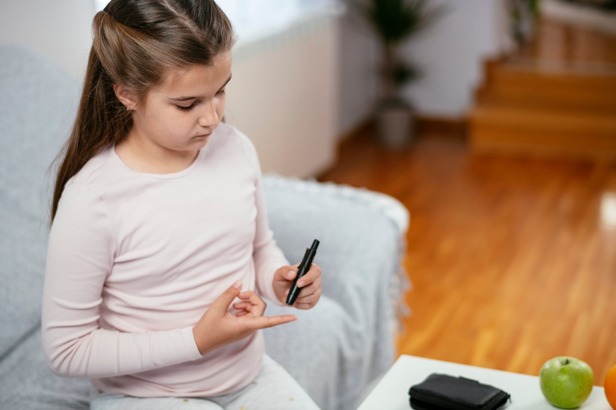Young girl checking her blood sugar.