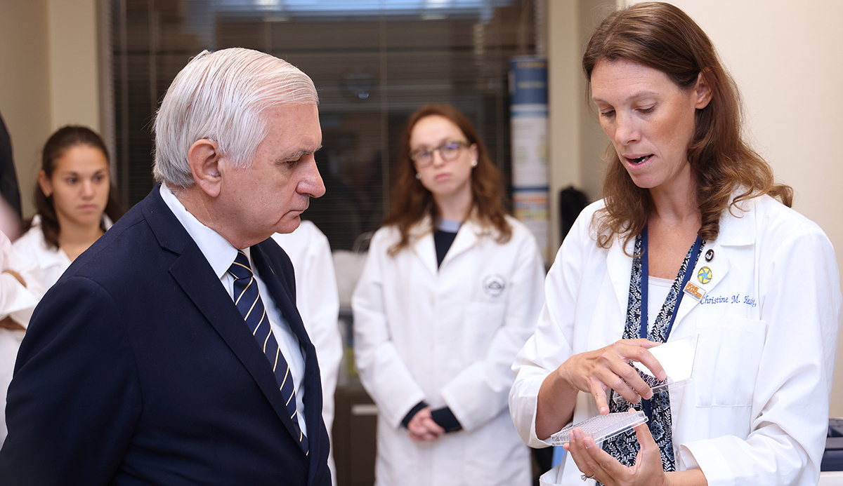 Senator Jack Reed discusses cancer research with Dr. Christie Heske, an investigator in the NCI Pediatric Oncology Branch.