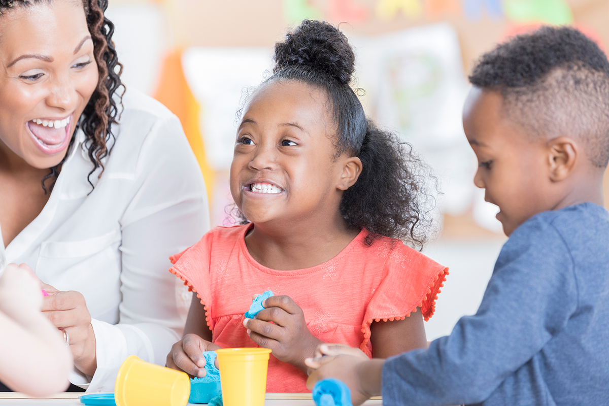 Image of a teacher and children.