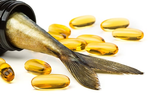 pill bottle with fish oil pills and a fish tail sticking out of the bottle