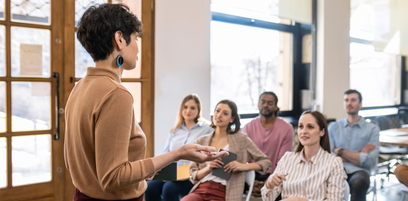 Female professor teaching a group of students