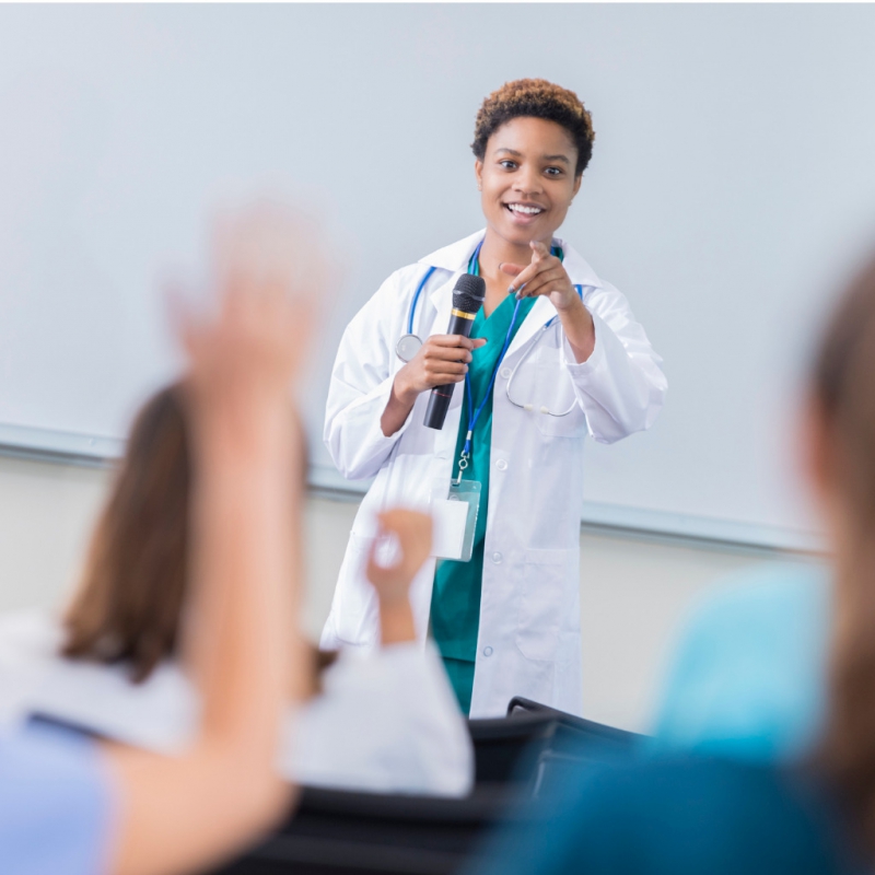 Female biomedical professor teaching students.