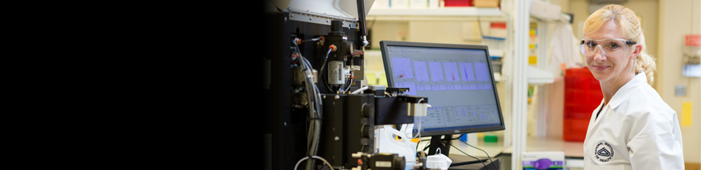 Researcher poses for an image while working in the lab