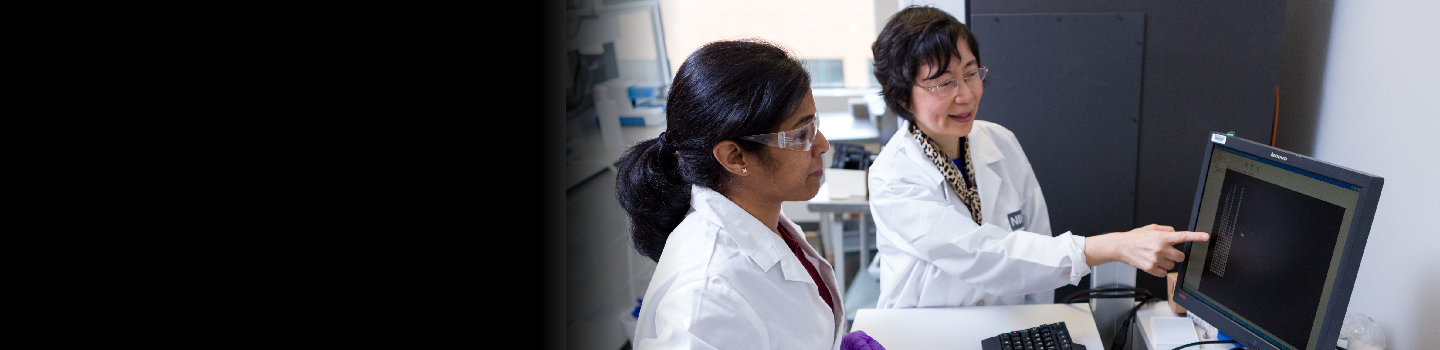 Two scientists looking at the computer.
