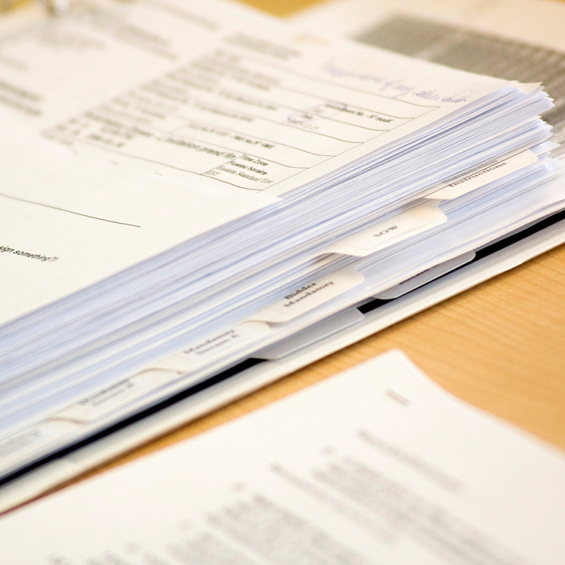 Binder with papers on office desk