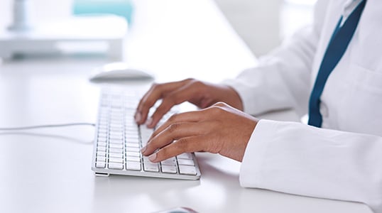 hands typing on keyboard
