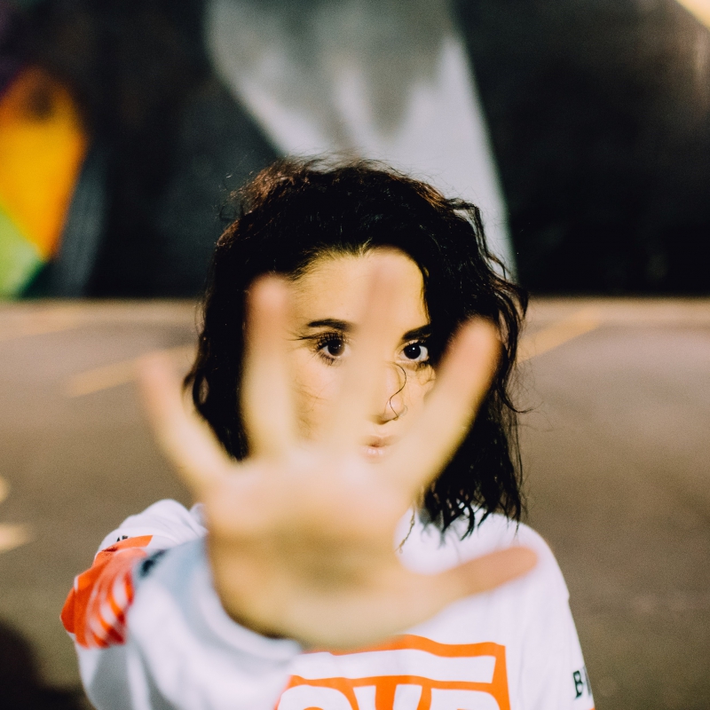 Woman holding hand in stop gesture.
