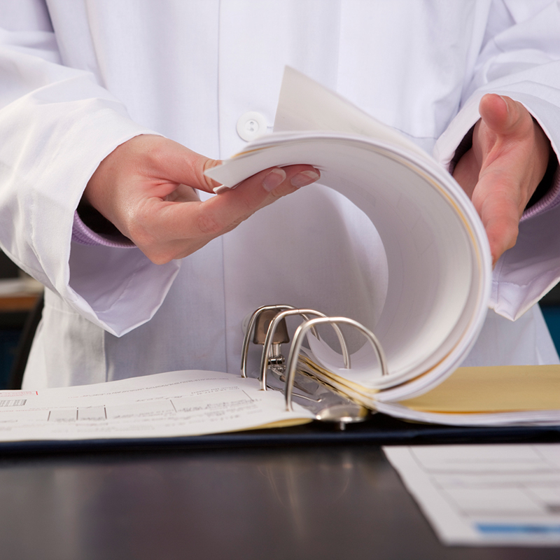 Scientist flipping through a report in the laboratory
