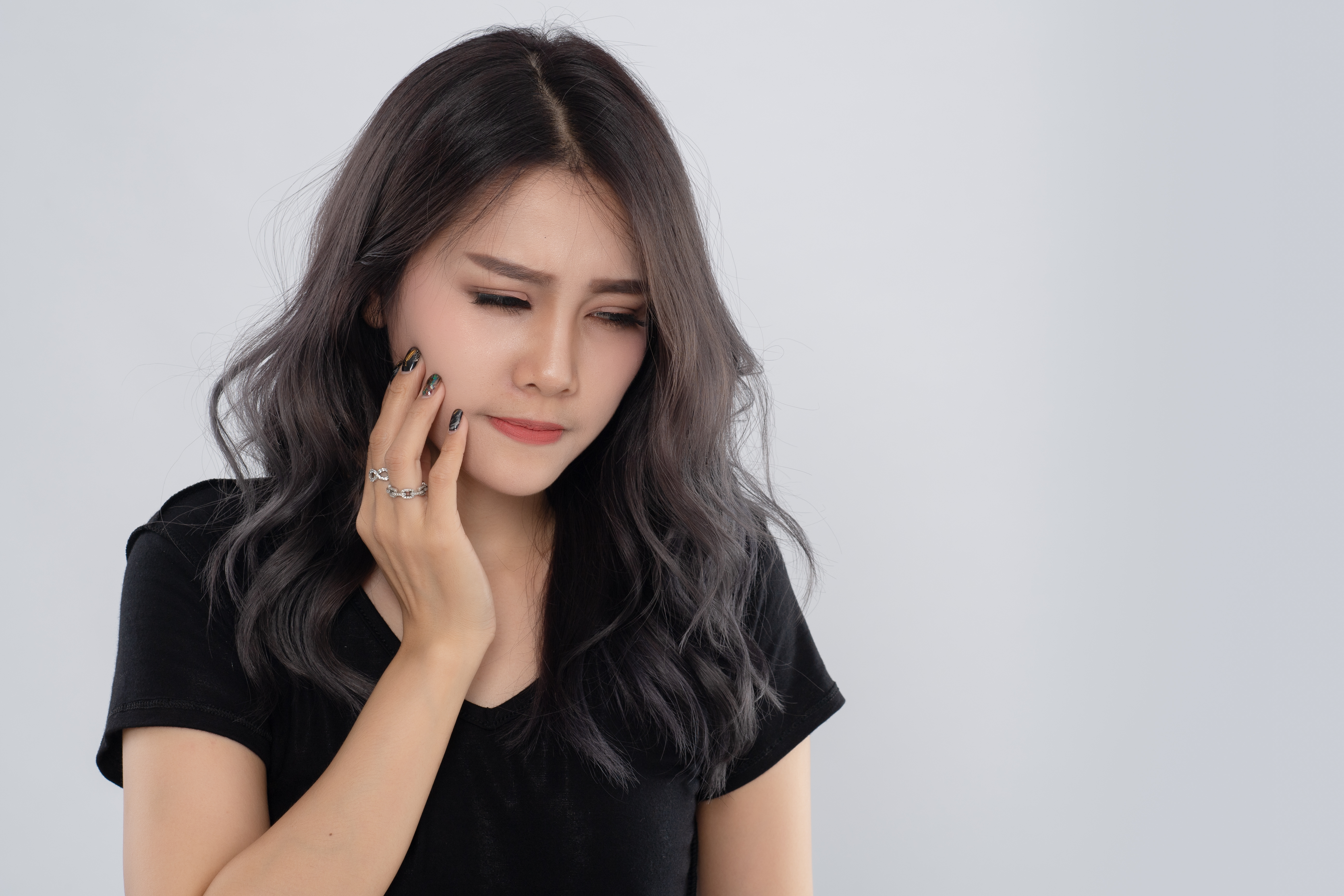 A woman touching her jaw