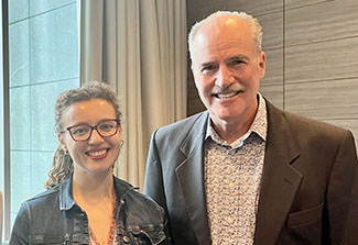 Acting Fogarty Director Peter Kilmarx (right) with Alonya Mazhanaya (left) smiling in Warsaw, Poland in June 2023