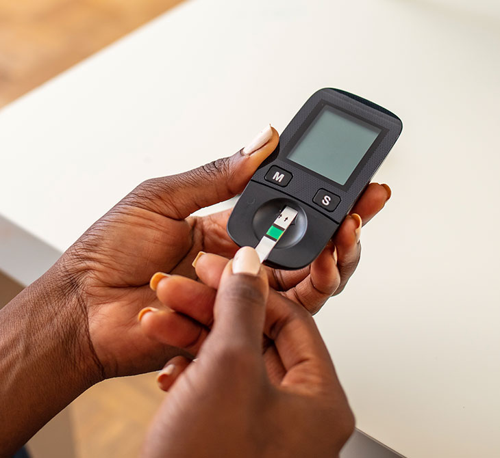 A person with diabetes checks their blood sugar