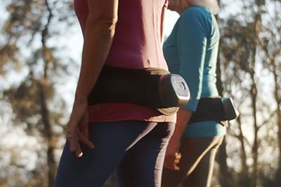 two people walking with Osteoboost belt on