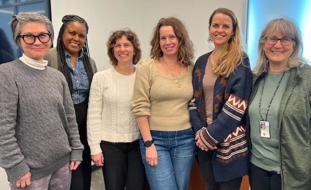 OITE well-being advisors standing in a group and smiling at the camera
