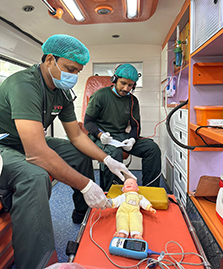 Paramedics practice saving an infants life using ambulance telemedicine