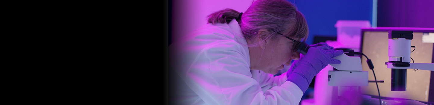NCATS scientists inspect microscope slides