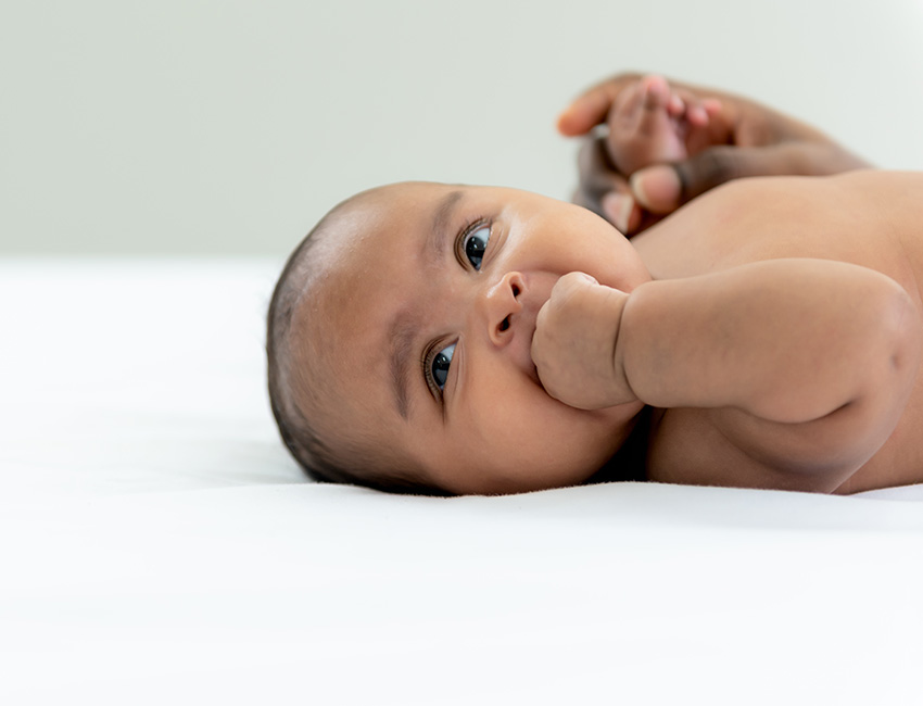 A baby is laying on their back.