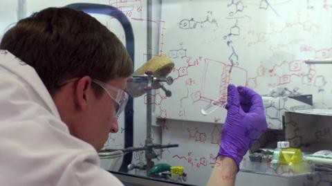 NCATS chemist with a test tube.