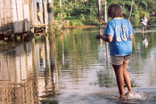 A woman walks through a flooded street.