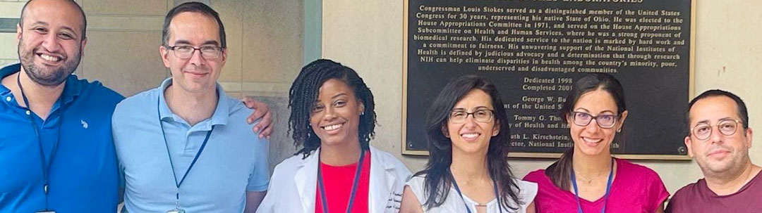 Photograph showing faces of the six lab members standing in a line.