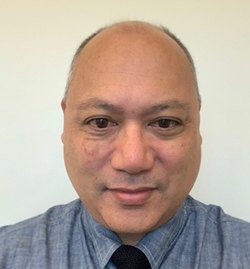 The photo on this page is a headshot of Don Operario wearing a blue shirt and black tie