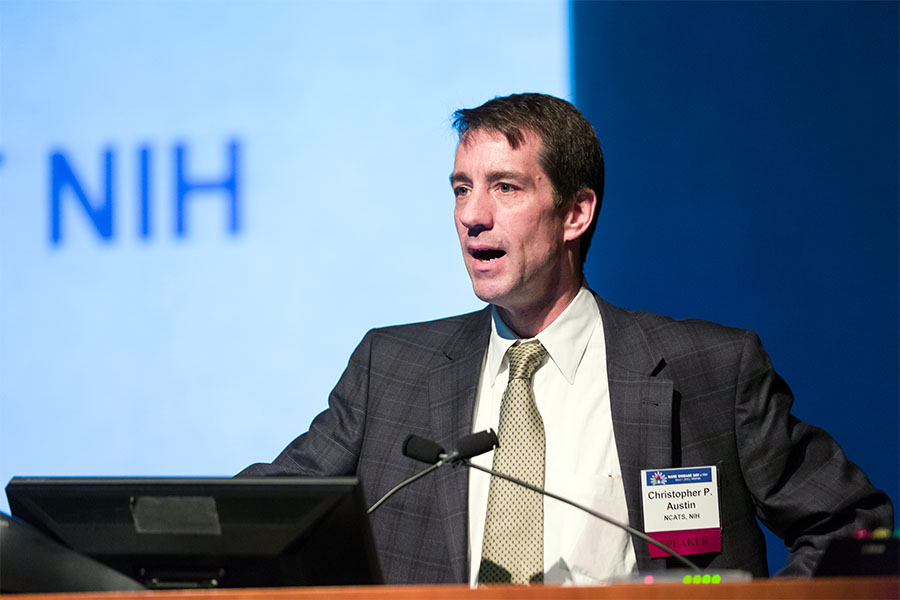 Christopher Austin speaking at a lectern.