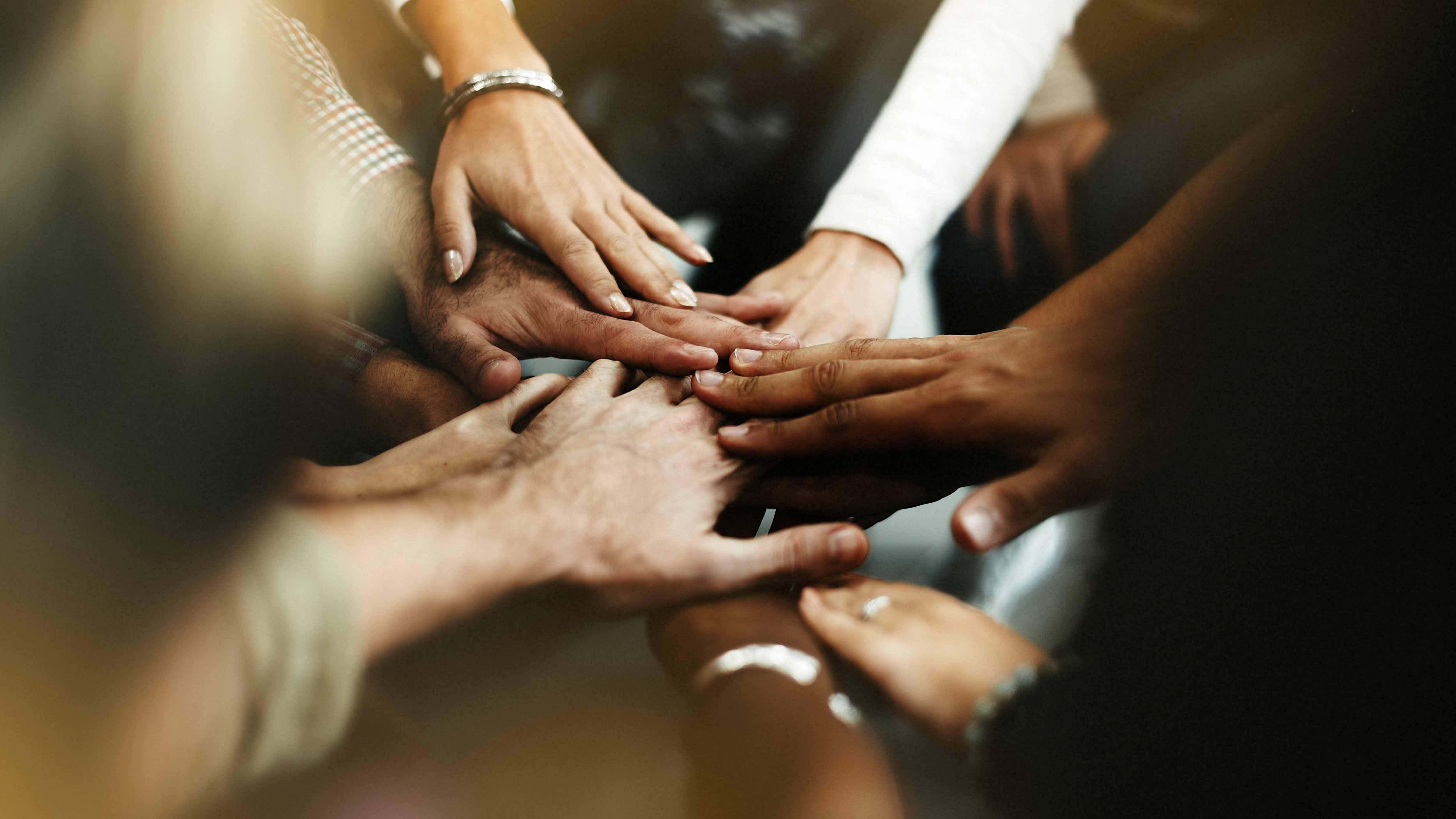 Multiple hands together symbolizing team work