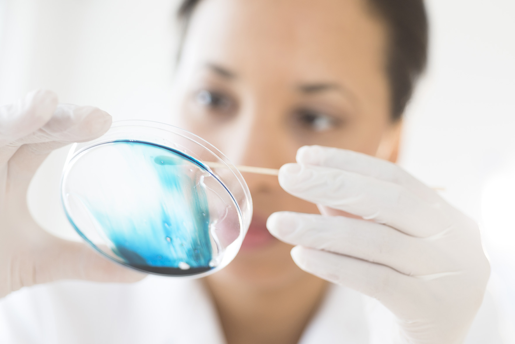 Decorative. Female scientist looking at test tube