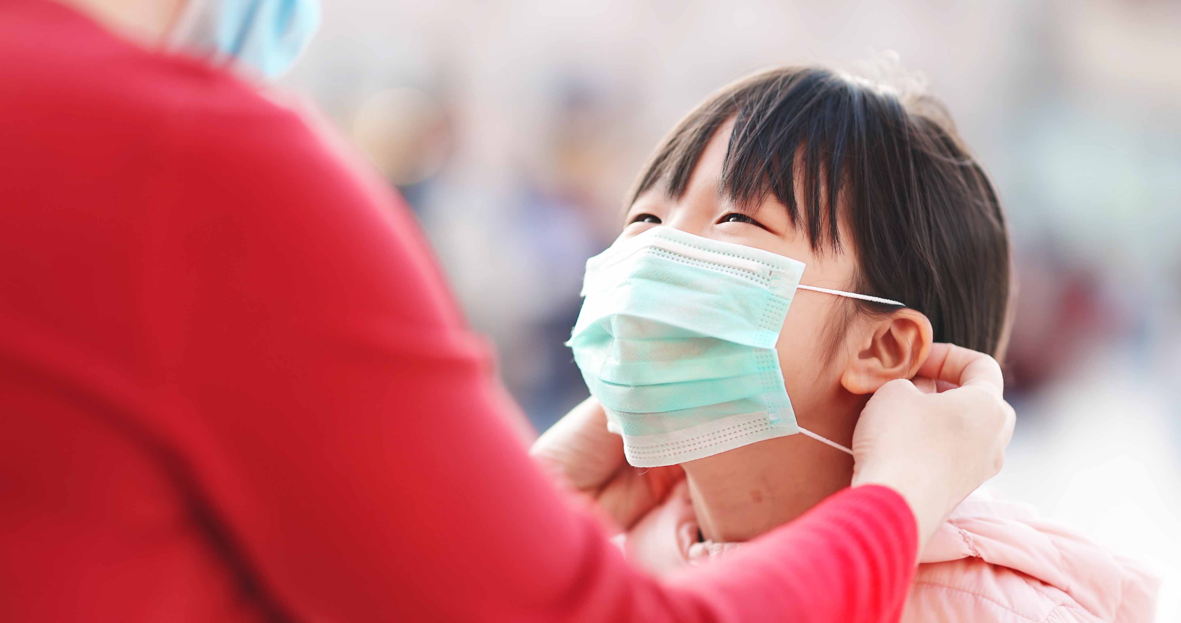 Asian child wearing a mask