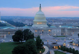 U.S. Capitol building as seen from the air in the evening.