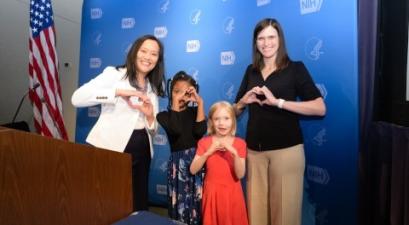 group standing with heart hands