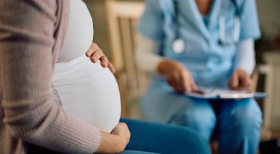 a pregnant woman with her doctor