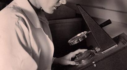 Dr. Ruth L. Kirschstein examining laboratory samples.