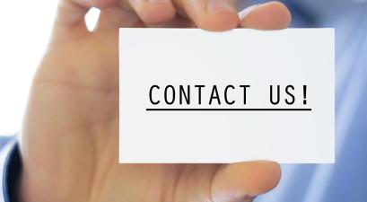 A hand holds a card that reads "Contact Us!"