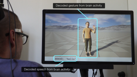 A person with a brain implant views a screen displaying a human avatar