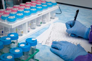 a scientist taking notes in a lab